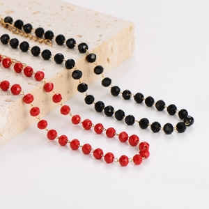 Minimalist beaded necklaces in red and black with faceted crystal charms on a stone base