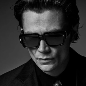 Retro oversized square sunglasses with black frames and metallic arrow stud accents