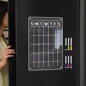 Magnetic acrylic weekly calendar on a black fridge with 6 colorful markers