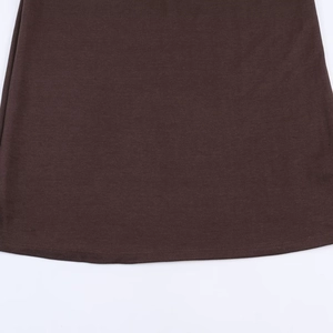 Detailed macro shot of the hemline stitching on this dark brown soft snap dress
