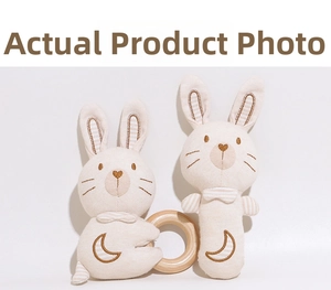 Detailed macro view of organic cotton baby rattle set with natural wooden ring handle