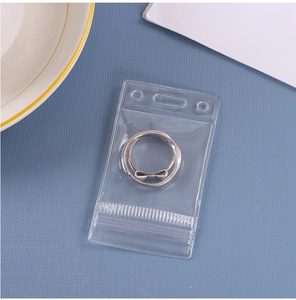 Detail of silver S925 bow ring inside a transparent PVC waterproof storage bag
