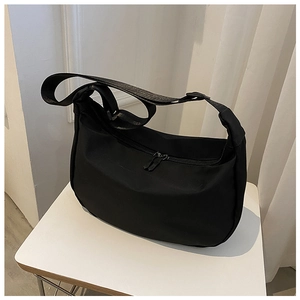 Detail of black crescent hobo bag made of oxford fabric with smooth double zippers