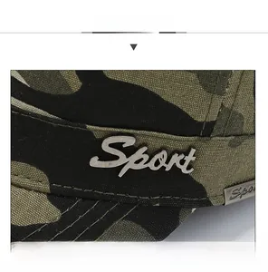 Detailed close-up of jungle camouflage fabric and metal Sport logo on the flat top cap