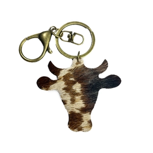 Vintage western cow head keychain in brown and white cowhide with bronze metal clasp