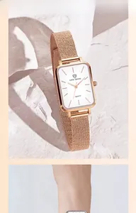 Close-up of a rose gold rectangular quartz watch featuring a Milanese mesh strap for women