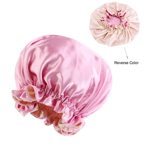 Detail view of double-layered satin bonnet showing reversible pink and champagne colors
