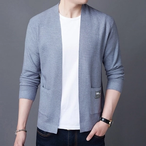 Close-up of light blue knit cardigan texture with V-neck and branded pocket patch