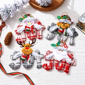 Detail of fabric JOY Christmas ornaments with plush Santa, reindeer, snowman and bear