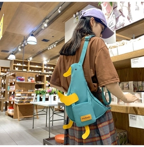 Cute blue duck-shaped canvas crossbody bag with adjustable straps and front pocket