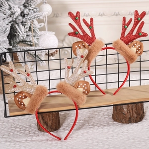 Detail of Christmas reindeer antler headbands with festive glitter and plush ear accents