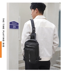 Rear view of model wearing a black waterproof nylon chest bag with adjustable straps