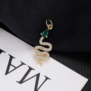 Detailed view of a gold snake pendant with emerald drop stone and pave zircon accents