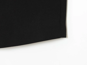 Detailed close-up view of the black plain weave fabric texture for the suit pants set