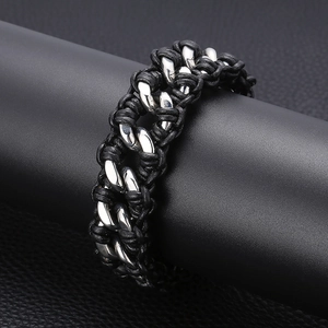 Close-up of men's stainless steel Cuban chain interwoven with black braided leather strap