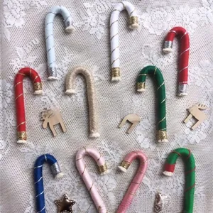 Detail of colorful knitted candy cane ornaments with metallic wire and beige tassels