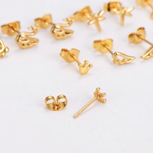 Set of gold stainless steel stud earrings featuring crown, swan, and dragonfly shapes