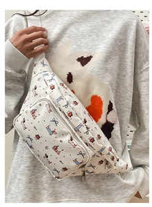 Detail of cute cartoon dachshund print and bow design on white fabric chest bag