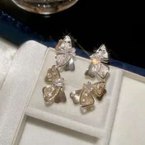 Elegant bow-shaped stud earrings with sparkling cubic zirconia set in high-quality silver pins