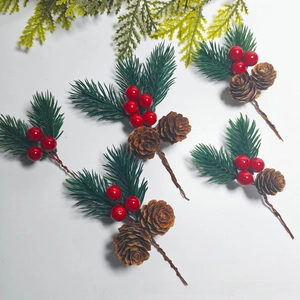 Detail of DIY Christmas picks with pine cones, red berries and green pine needles