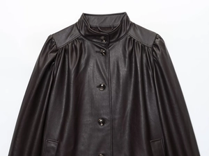 Detail of dark brown leather jacket with stand collar and pleated shoulder seams