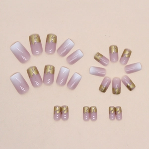Luxurious pearlescent pink press-on nails with golden foil and French gradient design
