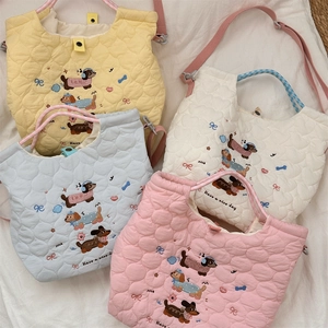 Detailed heart-quilted texture and cute embroidered dachshund motifs on multi-color bags