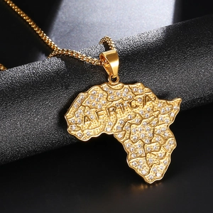 Macro detail of gold plated Africa map pendant necklace with crystal pave stones