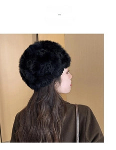 Detail of black handmade crochet rabbit fur knit hat with hollow flower pattern on back