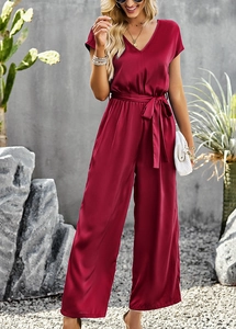 Detailed view of the red satin V-neck jumpsuit with short sleeves and tied waist belt