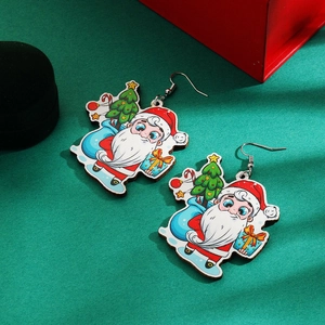 Detail view of Santa Claus earrings with Christmas tree and gift bag on a green background