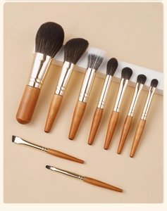 Detail view of 9-piece mini travel makeup brush set with wooden handles and gold ferrules