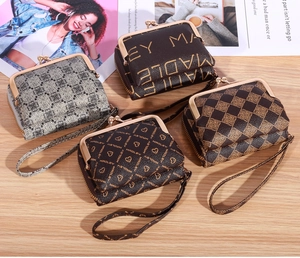 Detail view of retro small wallets with gold metal clasps and stylish wrist straps