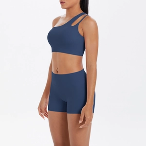 Detail of navy blue one-shoulder sports bra and high-waist shorts set for gym and yoga