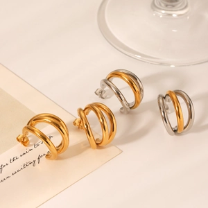 Detail of three-layer mixed gold and silver stainless steel hoop earrings on a decorative card