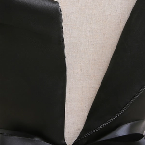Detail of the back hidden zipper and satin bow tie on this black Halloween dress