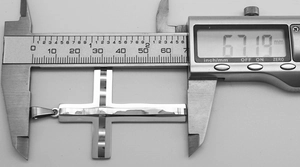 Digital caliper measuring the 67mm height of a punk silver cross pendant for size reference