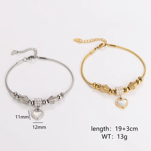Gold and silver heart charm snake chain bracelets with minimalist spiral beads on white
