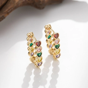 Gold hoop earrings featuring heart-shaped colorful zircons in a vintage minimalist design