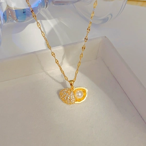 Elegant gold shell locket necklace with sparkling zircon pavé and a white pearl inside