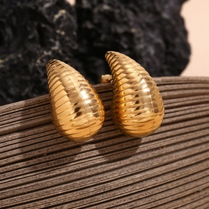 Macro shot of 18K gold plated hollow teardrop earrings with elegant striped texture