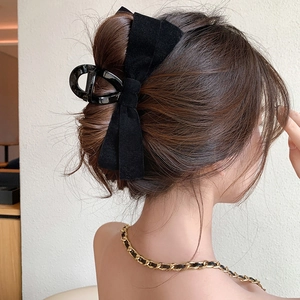 Elegant large black velvet bow hair claw clip for women's French style low bun hairstyles