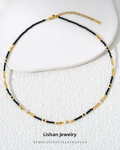 Macro detail of black spinel beaded necklace with 18k gold plated titanium clasp