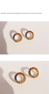 Detail shot of golden circular earrings with rainbow gradient micro-paved zircons