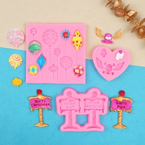 Detail of Christmas silicone molds for fondant showing balloon and signpost shapes