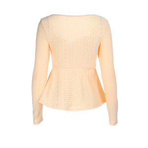 Detail of apricot peplum top featuring intricate eyelet lace and delicate hollow-out pattern