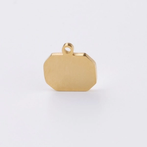 Close-up of a polished gold-plated octagonal stainless steel tag for DIY jewelry