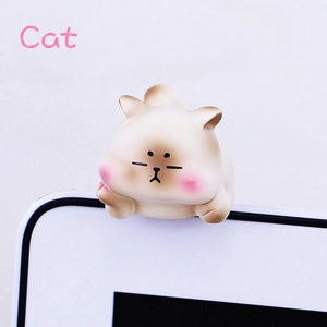 Close-up of cute mini cat resin ornament hanging on computer monitor edge decor
