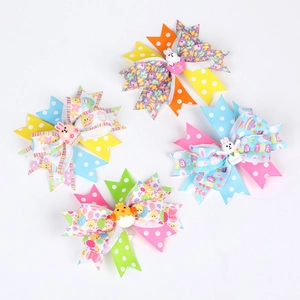 Detail of 4-piece Easter hair bow clips featuring cartoon bunnies and colorful polka dots
