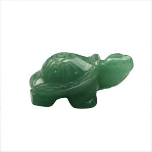 Hand-carved green aventurine turtle crystal figurine on a clean white background